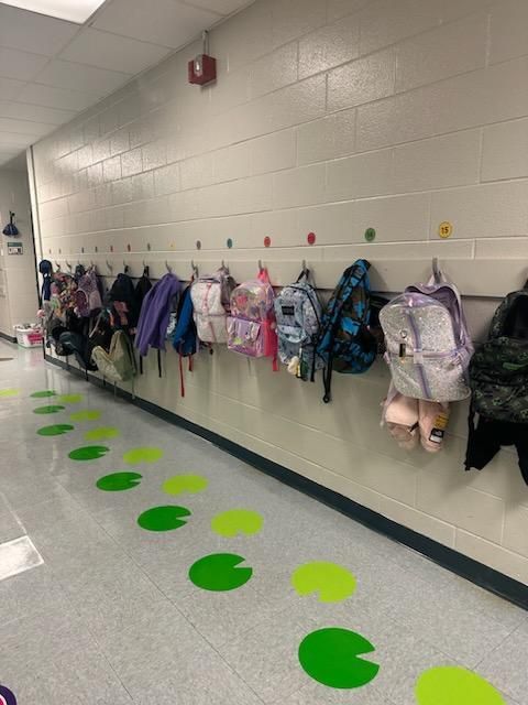 School hallway with backpacks hanging on hooks